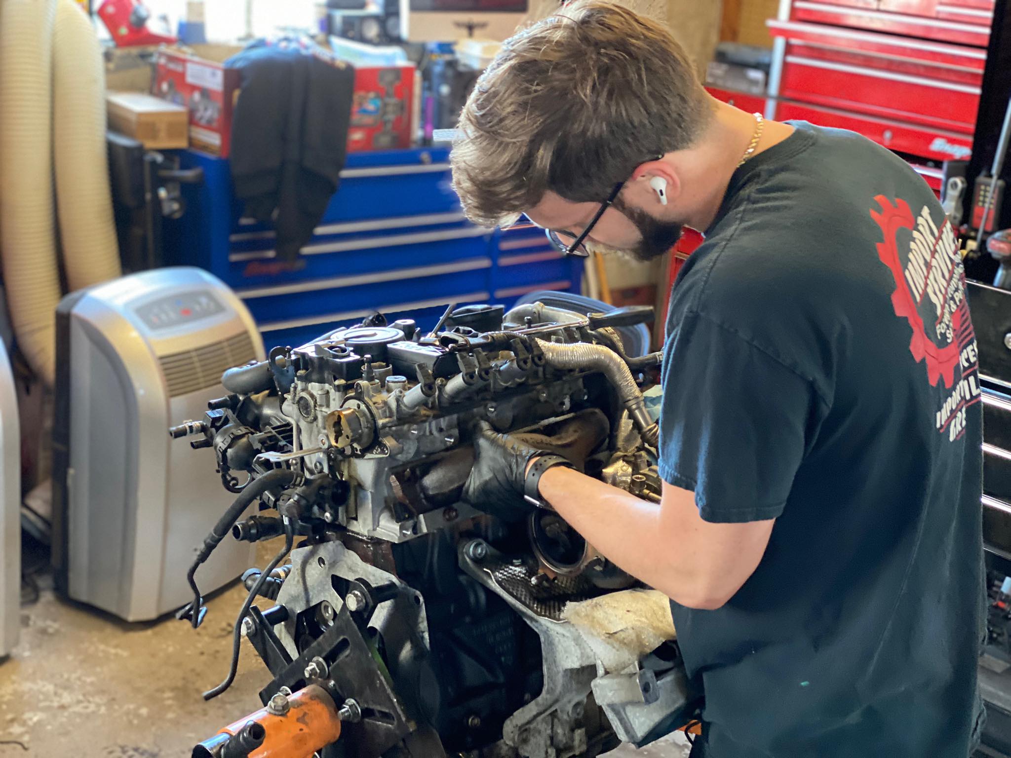 Technician repairing a European car engine