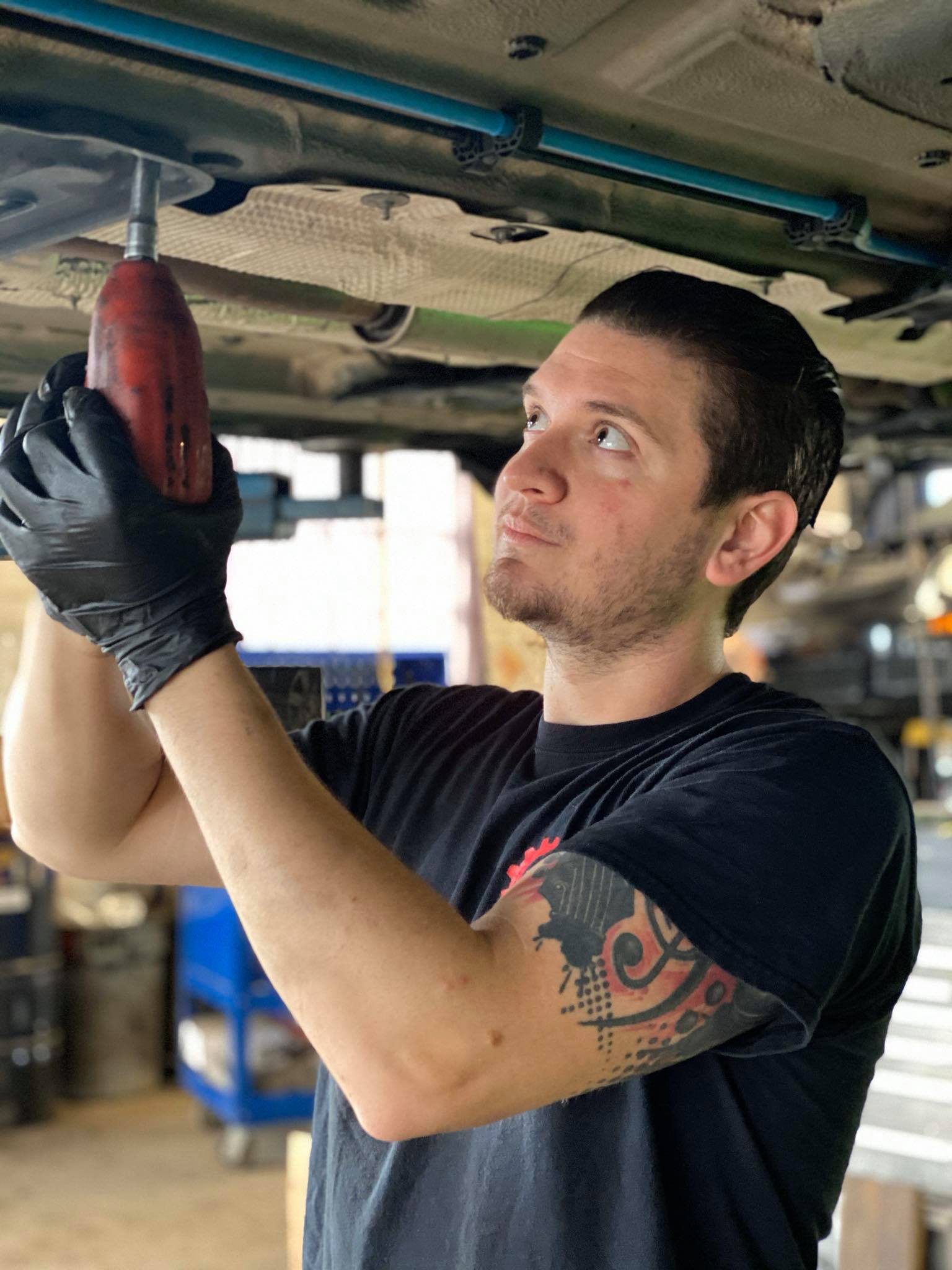 Technician working underneath a European vehicle