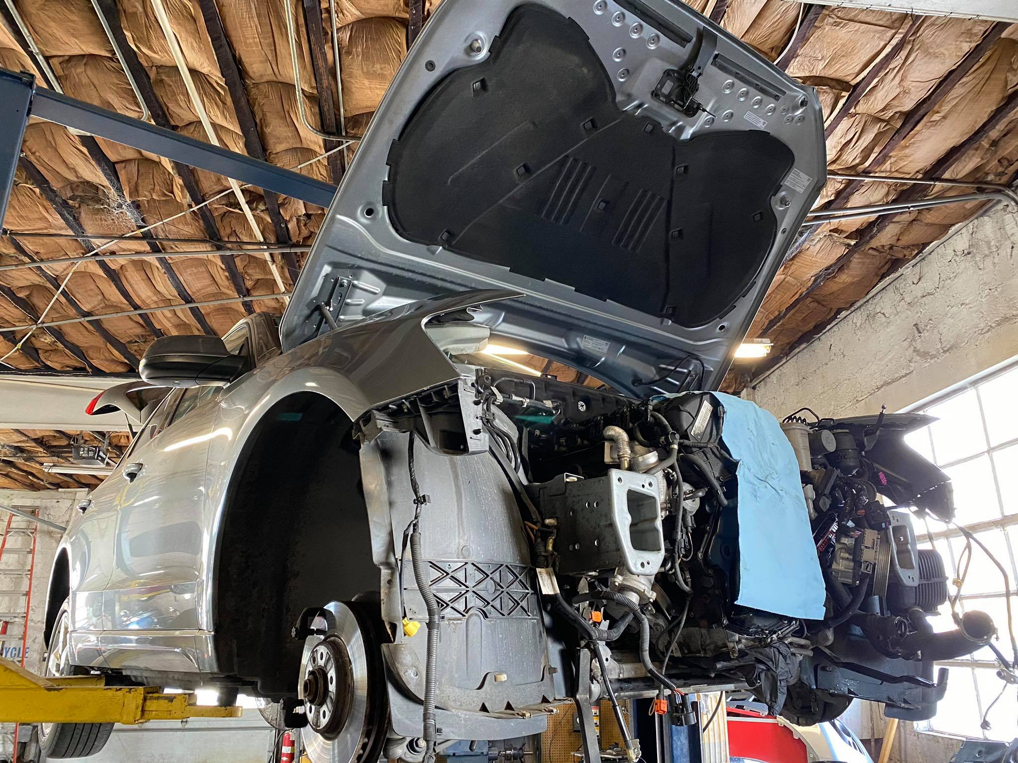 Classic VW Beetle being restored with front end removed at European auto shop